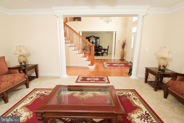 living room with ornamental molding, wood-type flooring, and decorative columns