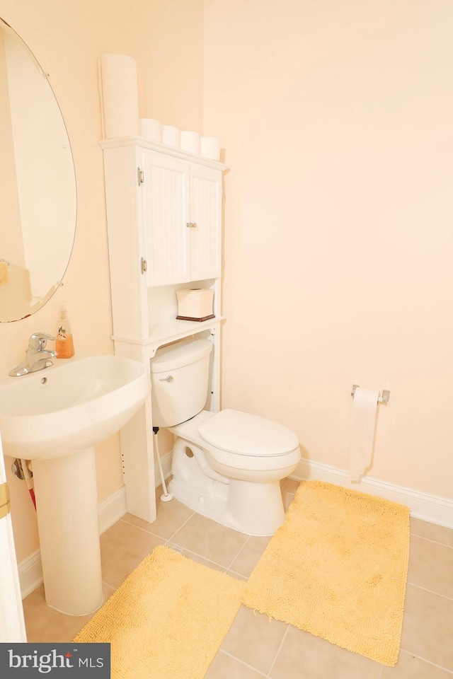 bathroom featuring tile patterned flooring and toilet