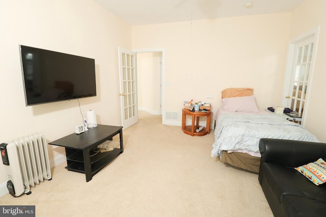 carpeted bedroom featuring radiator