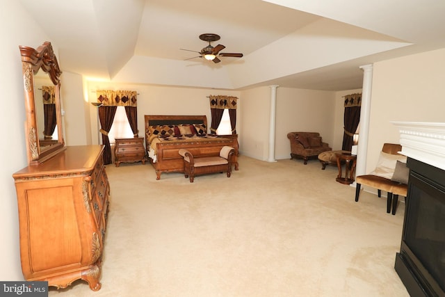 carpeted bedroom featuring a tray ceiling and ceiling fan