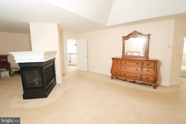 interior space featuring a multi sided fireplace and light carpet