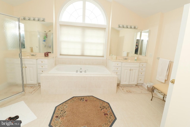 bathroom featuring independent shower and bath, lofted ceiling, vanity, and tile patterned floors