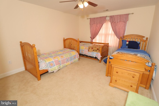 bedroom featuring ceiling fan and light colored carpet