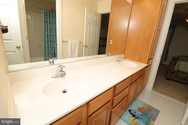 bathroom with shower / bath combo with shower curtain, tile patterned floors, and vanity