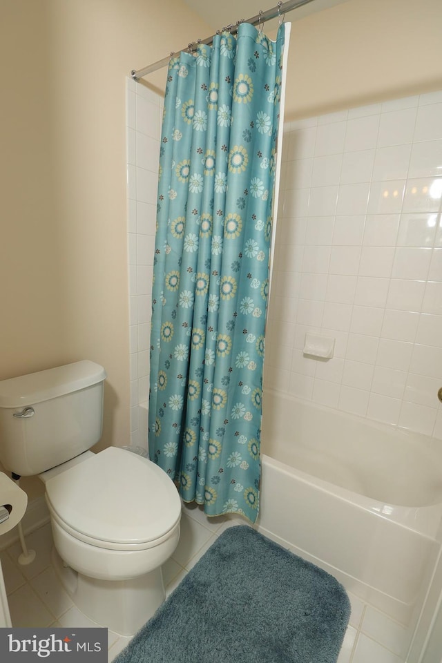 bathroom with shower / bath combination with curtain, tile patterned floors, and toilet