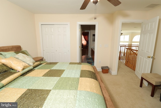 carpeted bedroom with a closet and ceiling fan