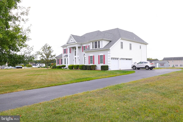 view of front of property with a garage and a front yard