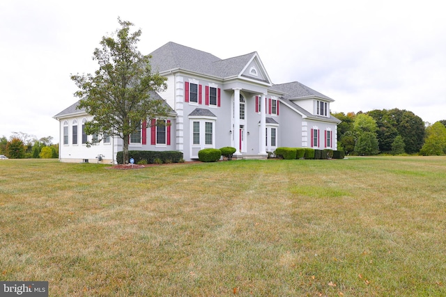 greek revival inspired property with a front yard