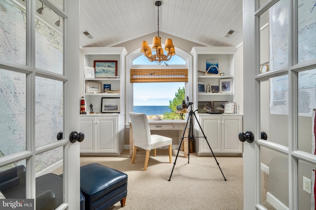 home office with lofted ceiling, light carpet, a water view, and a notable chandelier