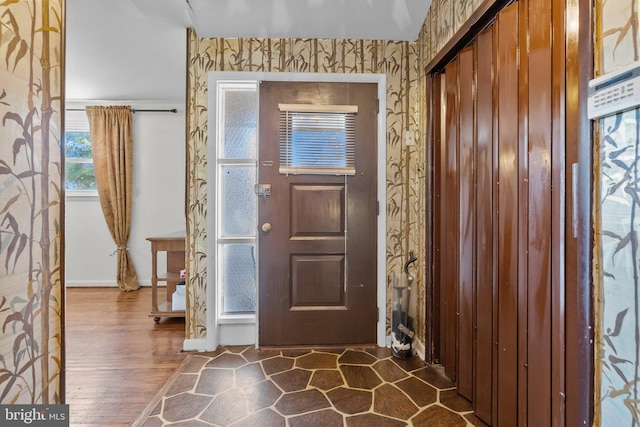 entryway with dark hardwood / wood-style floors