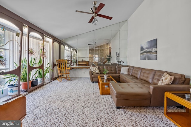 carpeted living room featuring high vaulted ceiling and ceiling fan