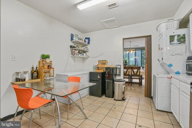 kitchen featuring white cabinets, a textured ceiling, and light tile patterned floors