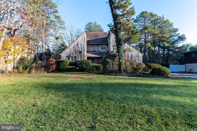 view of side of property with a lawn