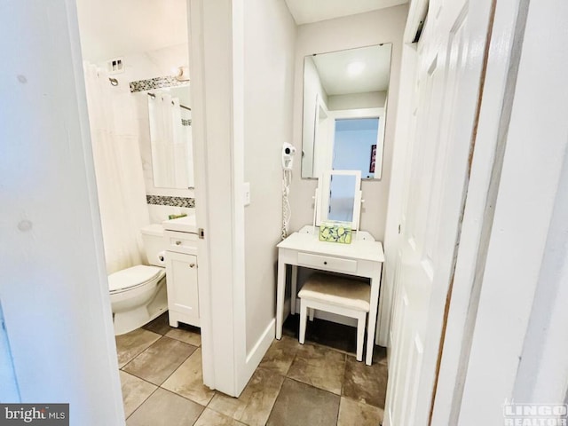 bathroom featuring vanity and toilet