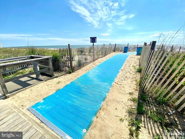 surrounding community featuring a water view and a swimming pool