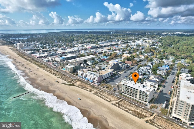 birds eye view of property with a view of the beach and a water view