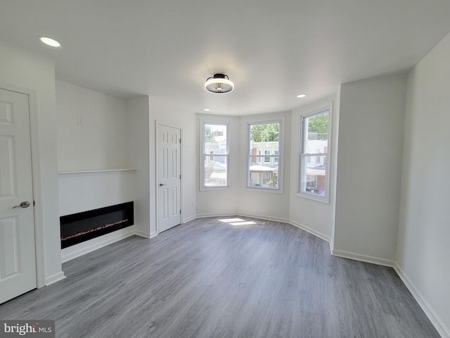 unfurnished living room with wood-type flooring