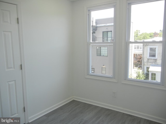 spare room featuring dark wood-type flooring