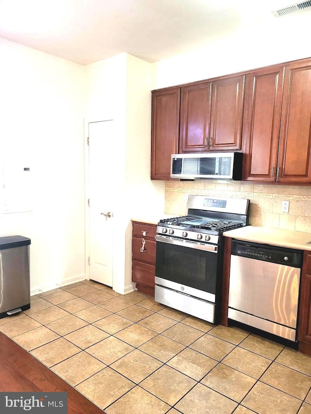 kitchen featuring appliances with stainless steel finishes and backsplash