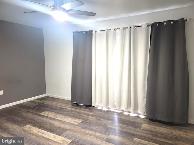 spare room with ceiling fan and dark hardwood / wood-style floors