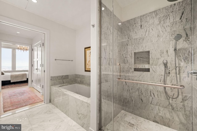 bathroom featuring shower with separate bathtub