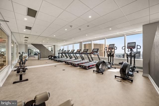 exercise room with a paneled ceiling