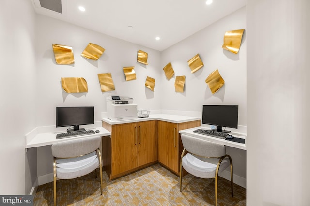 office space featuring built in desk and light hardwood / wood-style floors