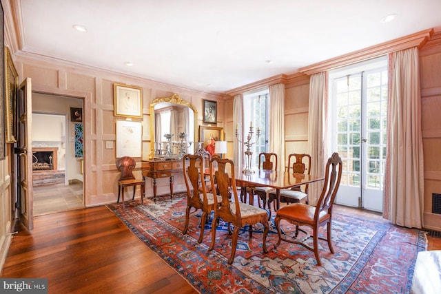 dining space featuring dark hardwood / wood-style floors and crown molding