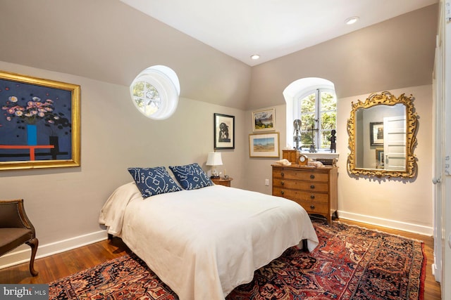 bedroom with dark hardwood / wood-style floors and vaulted ceiling