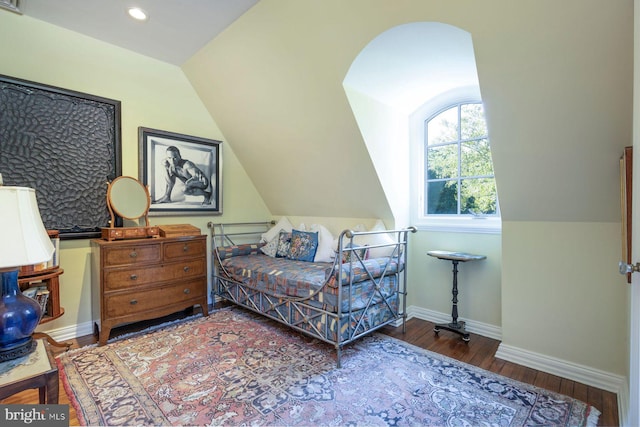 bedroom with wood-type flooring and vaulted ceiling