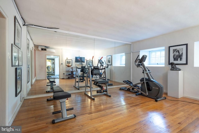 workout room with light hardwood / wood-style flooring