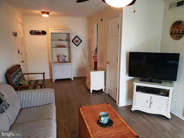 living room featuring crown molding, dark hardwood / wood-style floors, and ceiling fan