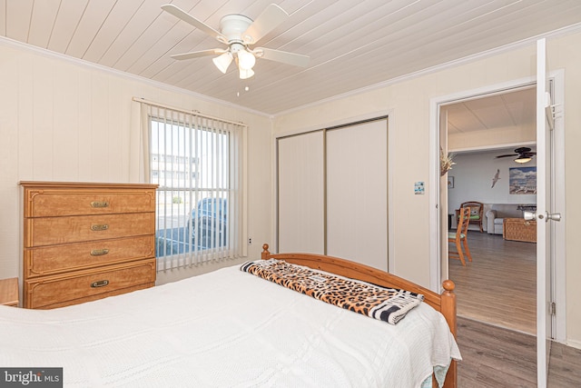 bedroom with wood-type flooring, ceiling fan, crown molding, and wood ceiling