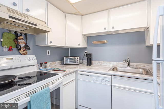 kitchen featuring white appliances, sink, and white cabinets