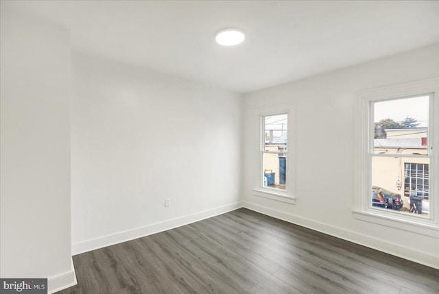 spare room with dark wood-type flooring