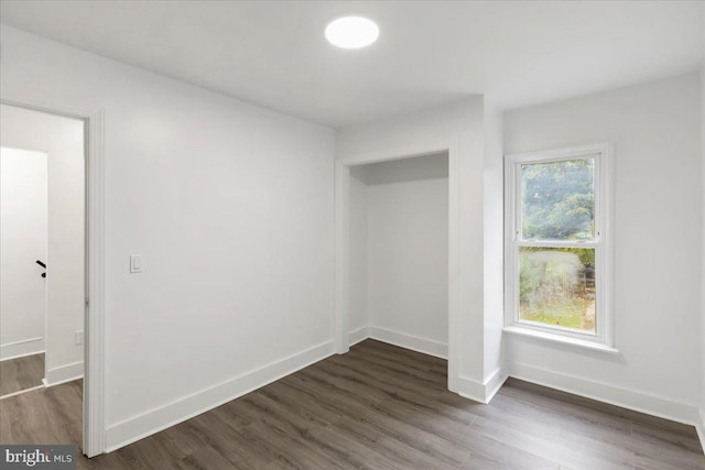 spare room with dark hardwood / wood-style floors