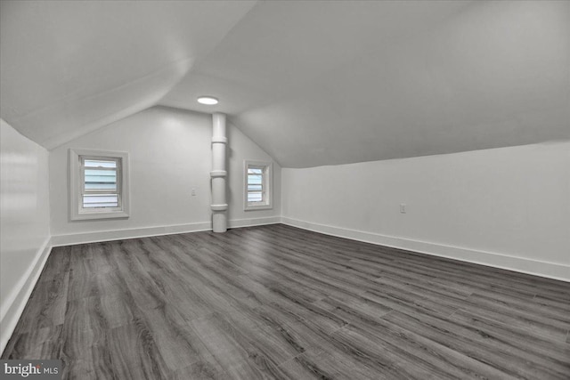 additional living space with lofted ceiling and dark wood-type flooring