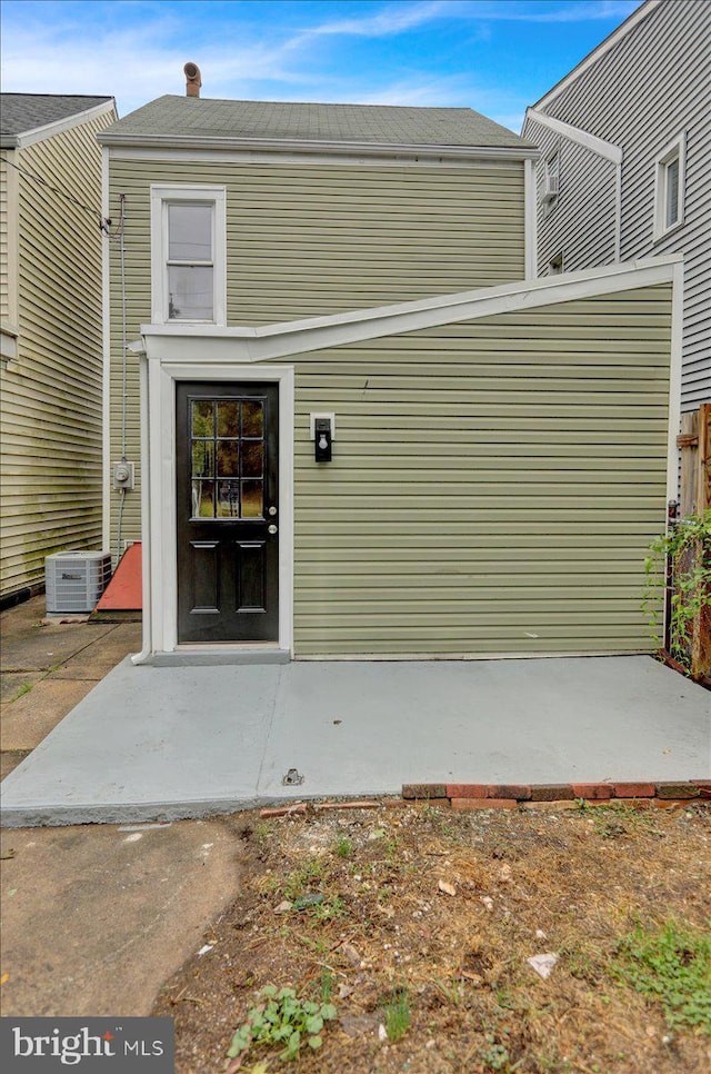 property entrance featuring cooling unit and a patio area