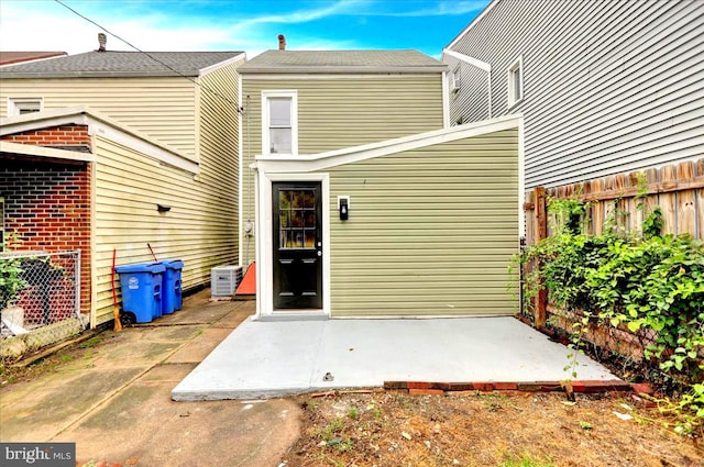 rear view of house featuring central AC unit and a patio area