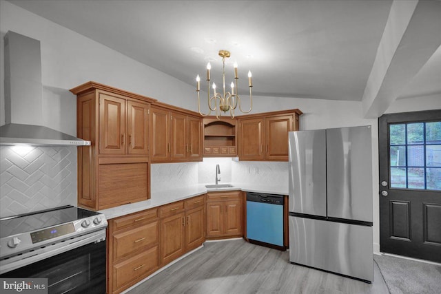 kitchen with wall chimney exhaust hood, backsplash, stainless steel appliances, a notable chandelier, and light wood-type flooring