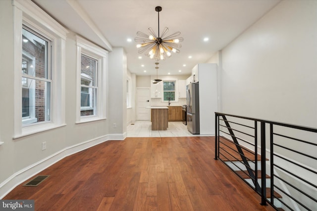 interior space featuring a notable chandelier, light hardwood / wood-style flooring, and sink