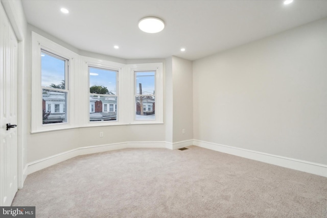 empty room featuring light carpet