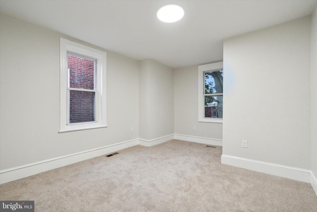 empty room featuring light carpet