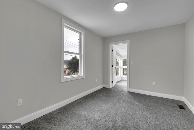 unfurnished room with carpet flooring