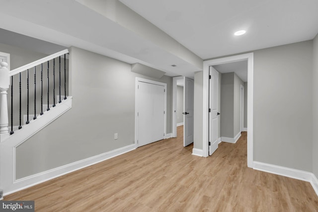 basement with light hardwood / wood-style flooring