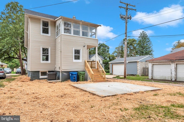 back of property featuring an outdoor structure and a garage