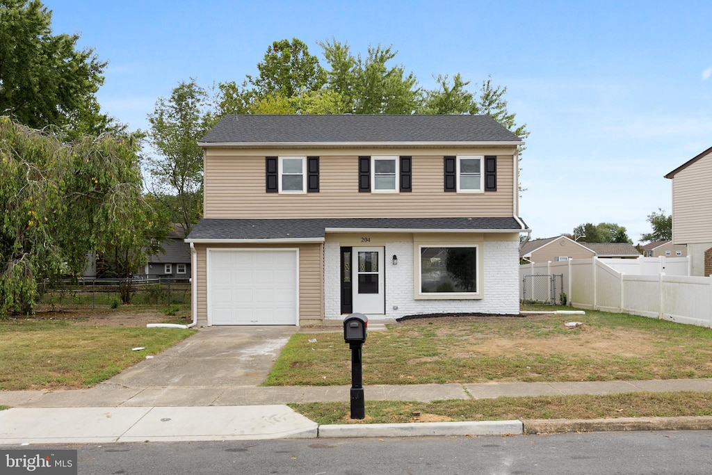 view of front facade featuring a front yard and a garage