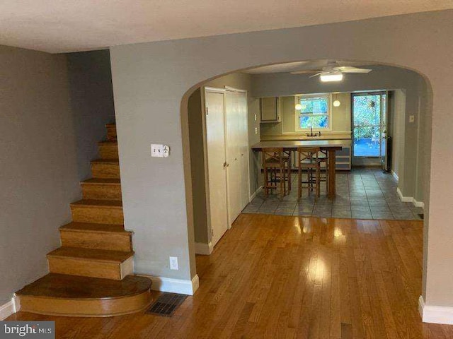 interior space with hardwood / wood-style floors, ceiling fan, and sink