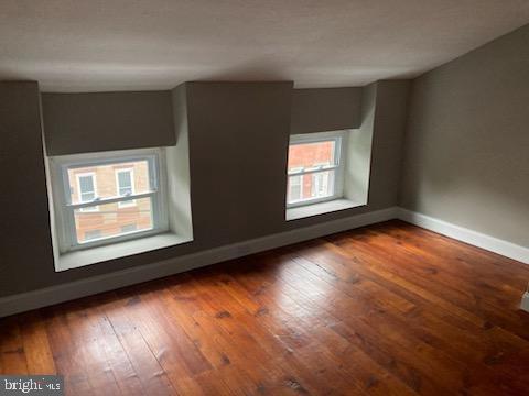 spare room with dark hardwood / wood-style flooring