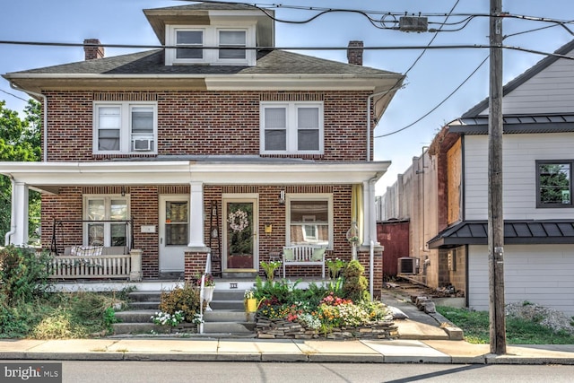 view of front of house featuring a porch and central air condition unit